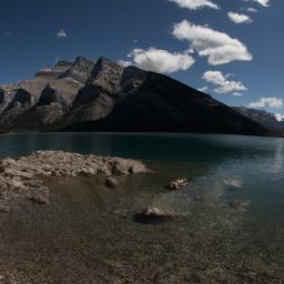 Lake Minnewanka erstrahlt in vollem Glanz: Aufgenommen mit einem Weitwinkelobjektiv direkt vor dieser atemberaubenden Sehenswürdigkeit in Banff